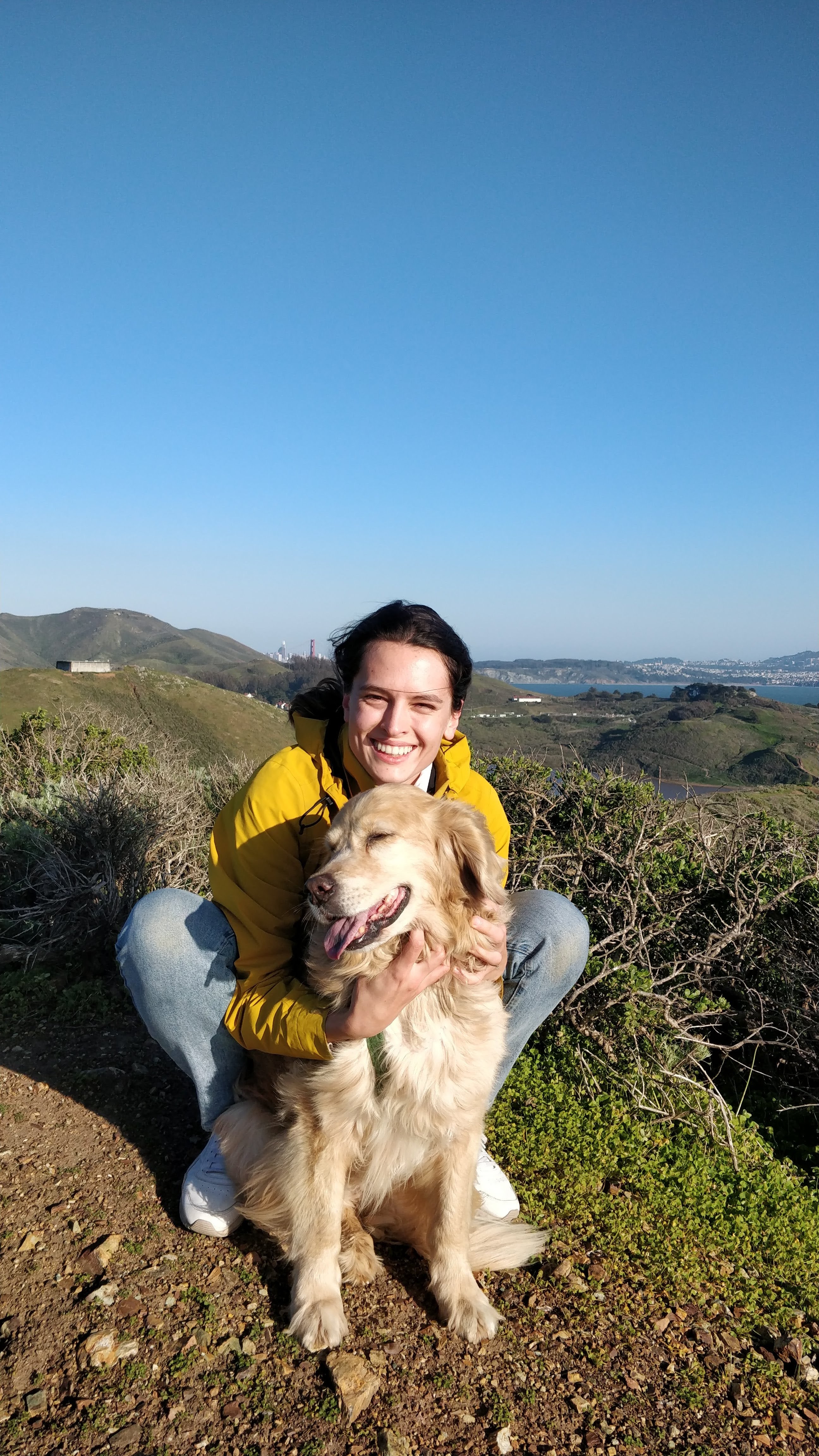 Klara Kaleb with Coco, her golden retriever, on a coastal hike
